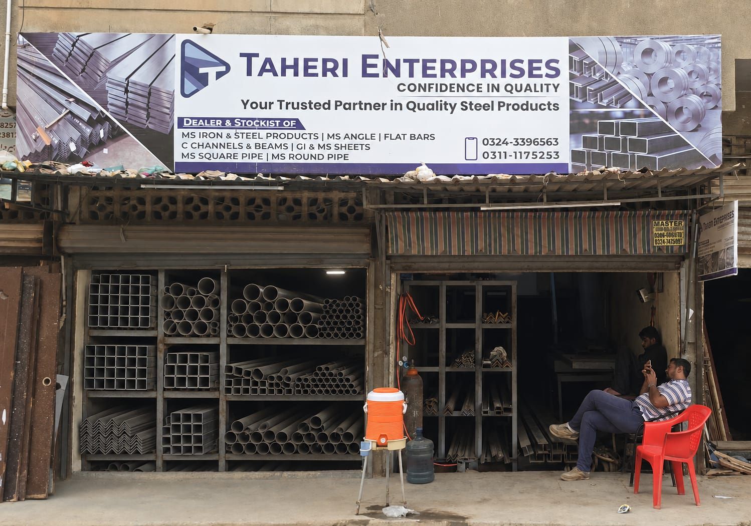 Taheri Enterprises shop in Old Haji Camp, Karachi - MS pipe, angle and channel stacked on the racks